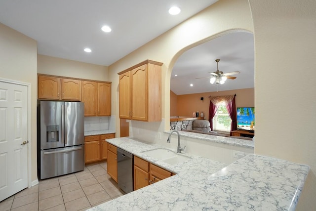 213 S Buffalo Pass, Georgetown, TX 78633 - kitchen featuring stainless steel appliances, ceiling fan, arched walkways, light tile patterned flooring, and light stone countertops