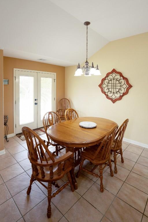 213 S Buffalo Pass, Georgetown, TX 78633 - dining room with french doors, lofted ceiling, and light tile patterned floors