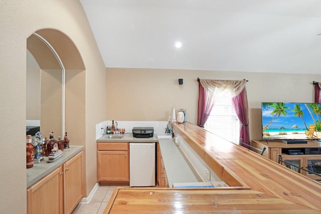 213 S Buffalo Pass, Georgetown, TX 78633 - kitchen featuring lofted ceiling, light tile patterned flooring, and white dishwasher