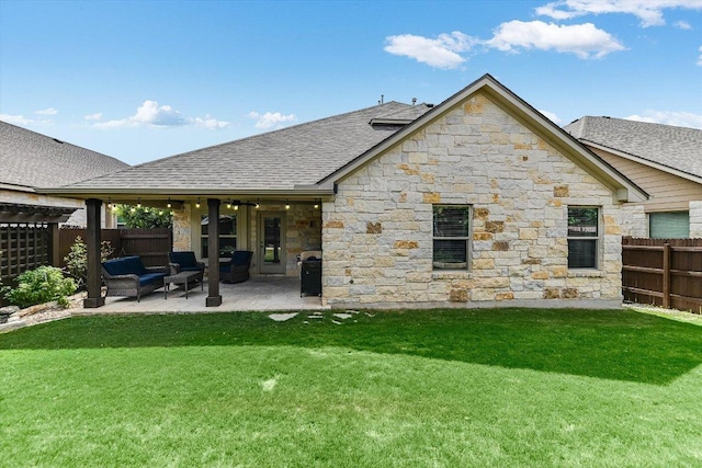 609 Joppa Rd, Leander, TX 78641 - back of house featuring a patio area, stone siding, a fenced backyard, and roof with shingles