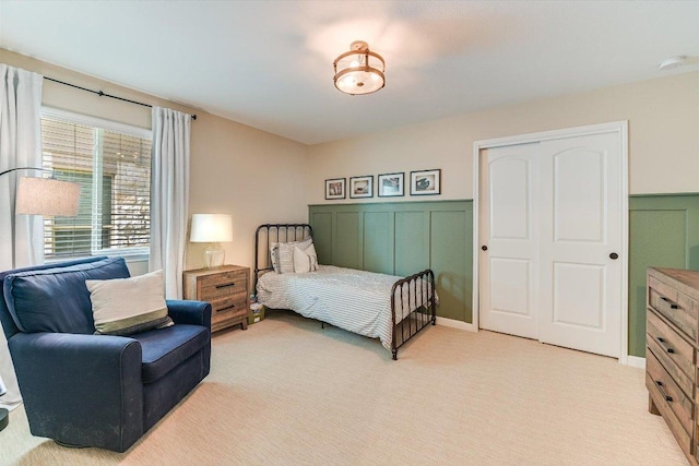 609 Joppa Rd, Leander, TX 78641 - bedroom with light colored carpet, a closet, and wainscoting