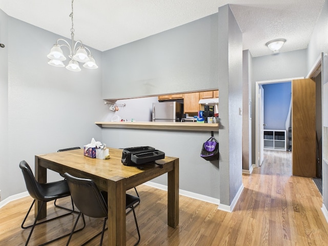 2901 San Jacinto Blvd Unit 110, Austin, TX 78705 - dining space featuring light wood-style floors and a chandelier