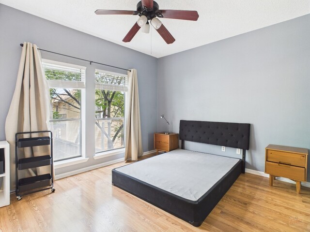 2901 San Jacinto Blvd Unit 110, Austin, TX 78705 - bedroom featuring wood finished floors and ceiling fan