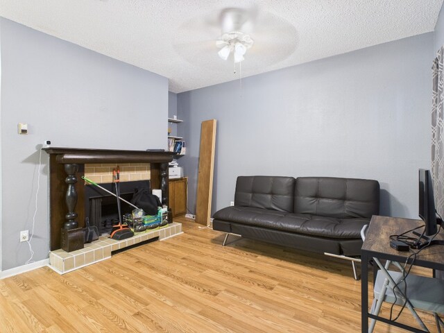 2901 San Jacinto Blvd Unit 110, Austin, TX 78705 - living room with a ceiling fan, wood finished floors, and a textured ceiling