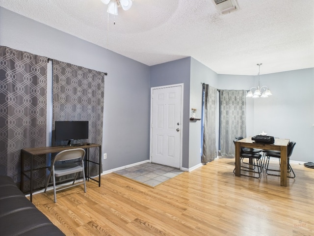 2901 San Jacinto Blvd Unit 110, Austin, TX 78705 - living area with wood finished floors, an office area, a chandelier, a textured ceiling, and ceiling fan