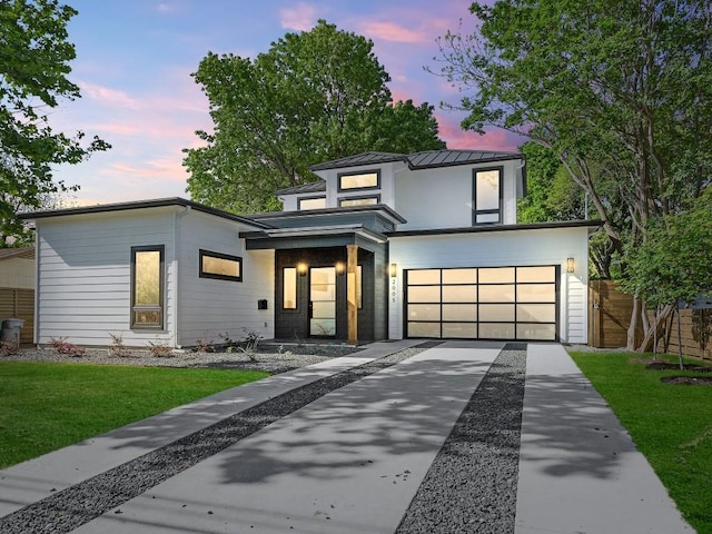 2005 Palo Duro Rd, Austin, TX 78757 - contemporary home featuring concrete driveway, an attached garage, and a standing seam roof