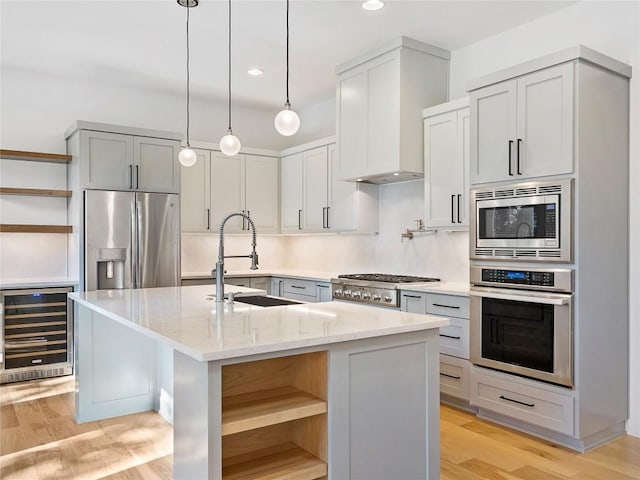 2005 Palo Duro Rd, Austin, TX 78757 - kitchen with wine cooler, open shelves, appliances with stainless steel finishes, light stone countertops, and a center island with sink