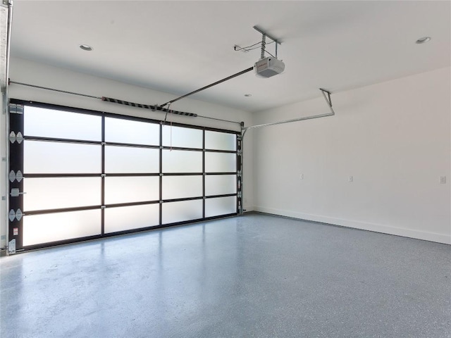 2005 Palo Duro Rd, Austin, TX 78757 - garage featuring a garage door opener and baseboards