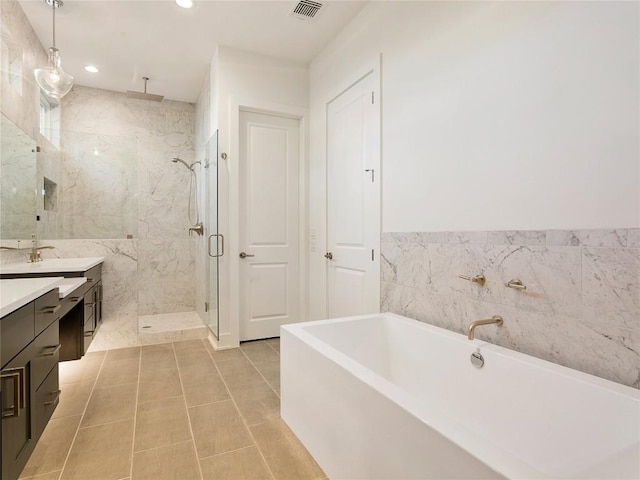 2005 Palo Duro Rd, Austin, TX 78757 - bathroom featuring a marble finish shower, vanity, a soaking tub, tile walls, and recessed lighting