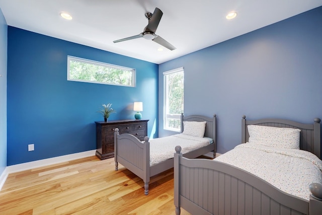 2005 Palo Duro Rd, Austin, TX 78757 - bedroom with multiple windows, light wood finished floors, recessed lighting, and ceiling fan