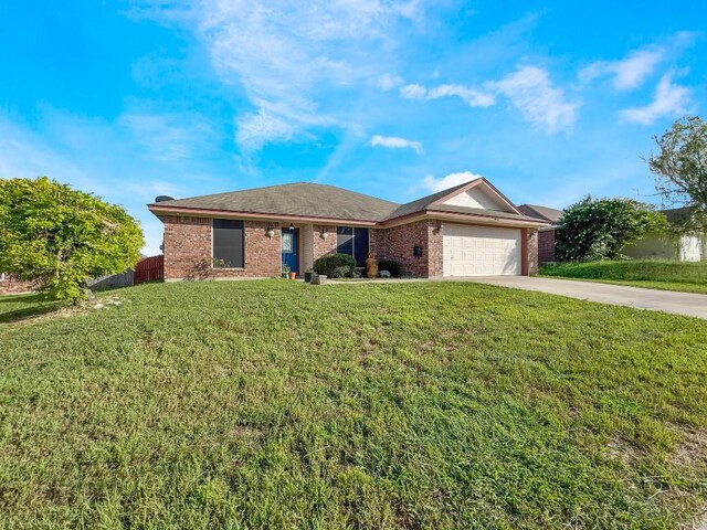 303 Rowdy Dr, Killeen, TX 76542 - ranch-style house with an attached garage, brick siding, and concrete driveway