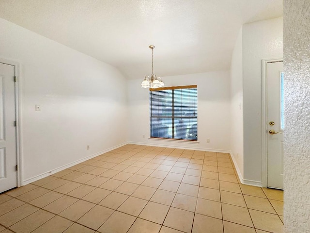 303 Rowdy Dr, Killeen, TX 76542 - spare room featuring a chandelier, light tile patterned flooring, and lofted ceiling