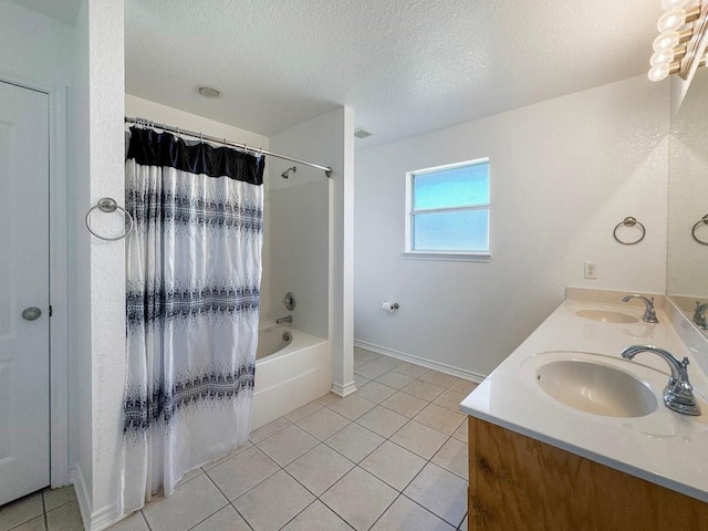 303 Rowdy Dr, Killeen, TX 76542 - full bathroom featuring tile patterned floors, double vanity, a textured ceiling, and shower / bath combo with shower curtain