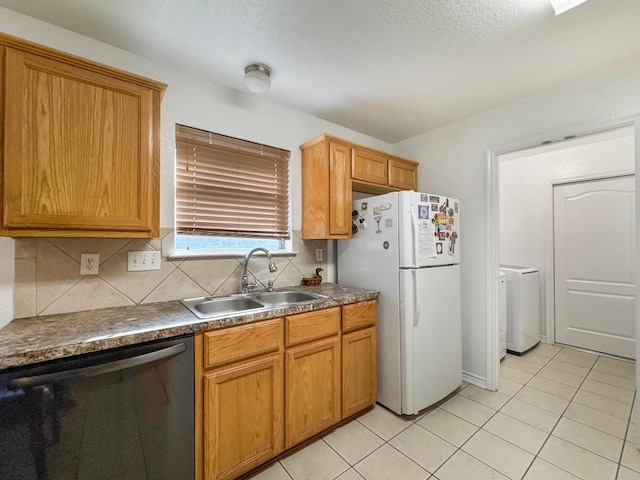 303 Rowdy Dr, Killeen, TX 76542 - kitchen featuring dishwashing machine, freestanding refrigerator, dark countertops, light tile patterned floors, and decorative backsplash