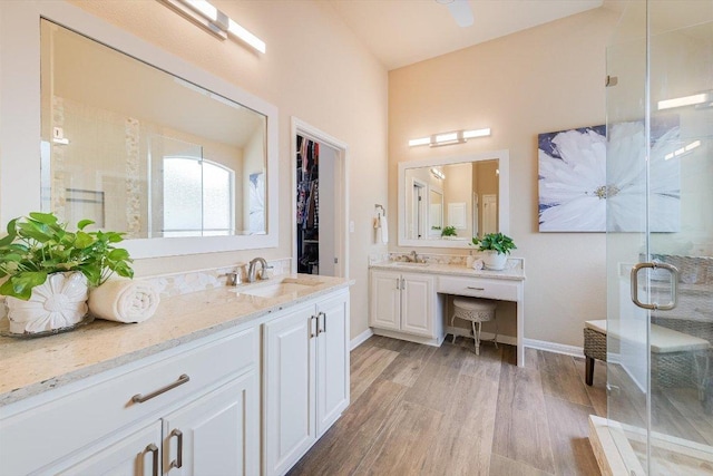 10320 Hansa Cv, Austin, TX 78739 - full bathroom featuring wood finished floors, a shower stall, and vanity