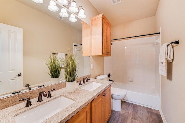 10320 Hansa Cv, Austin, TX 78739 - bathroom featuring double vanity, wood finished floors, and washtub / shower combination