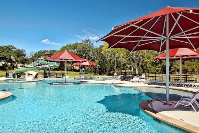10320 Hansa Cv, Austin, TX 78739 - community pool featuring a water slide, a patio area, and view of scattered trees