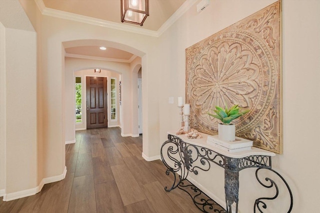 10320 Hansa Cv, Austin, TX 78739 - entrance foyer featuring ornamental molding, arched walkways, and wood finished floors