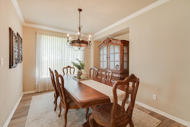 10320 Hansa Cv, Austin, TX 78739 - dining room with a chandelier, plenty of natural light, light wood-type flooring, and ornamental molding