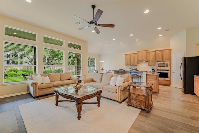 10320 Hansa Cv, Austin, TX 78739 - living room featuring light wood-style flooring, ceiling fan, and recessed lighting