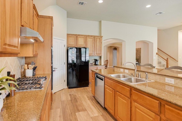 10320 Hansa Cv, Austin, TX 78739 - kitchen featuring stainless steel appliances, custom exhaust hood, arched walkways, decorative backsplash, and recessed lighting