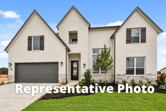401 Golden Sage Ave, Georgetown, TX 78633 - view of front of house with a garage, driveway, a front lawn, and brick siding