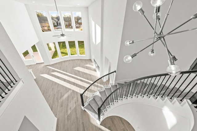 401 Golden Sage Ave, Georgetown, TX 78633 - staircase with a towering ceiling, wood finished floors, plenty of natural light, and a chandelier