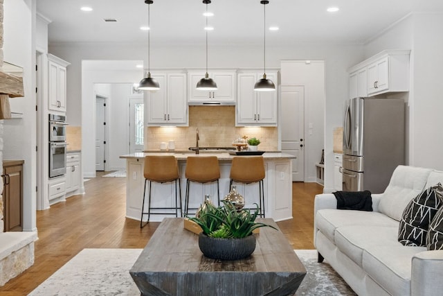377 Bristlecone Dr, Driftwood, TX 78619 - kitchen with appliances with stainless steel finishes, open floor plan, white cabinetry, backsplash, and recessed lighting