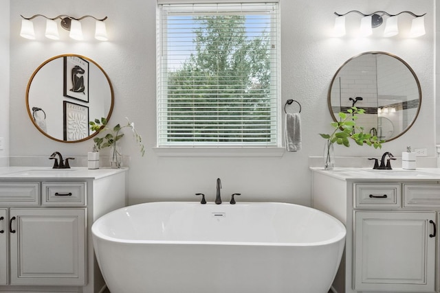 377 Bristlecone Dr, Driftwood, TX 78619 - bathroom featuring two vanities and a freestanding tub