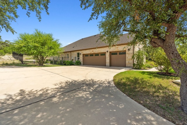 377 Bristlecone Dr, Driftwood, TX 78619 - view of front facade featuring concrete driveway, stone siding, an attached garage, and a shingled roof