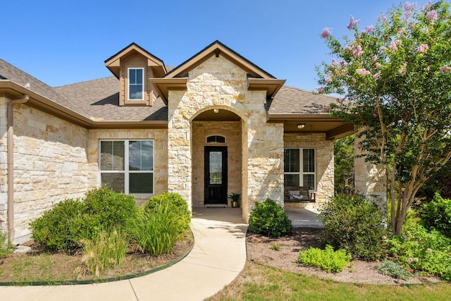 377 Bristlecone Dr, Driftwood, TX 78619 - entrance to property featuring stone siding and a shingled roof