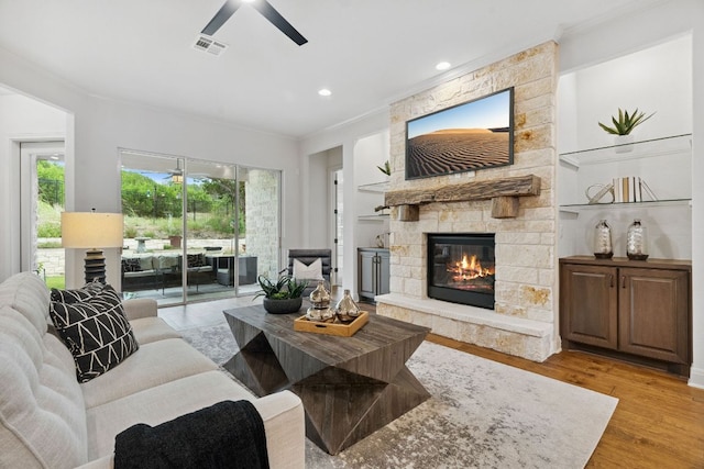 377 Bristlecone Dr, Driftwood, TX 78619 - living room featuring a ceiling fan, ornamental molding, a fireplace, light wood-style flooring, and recessed lighting