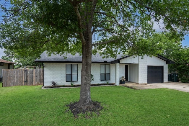 1004 Scenic Dr, Georgetown, TX 78626 - mid-century modern home featuring an attached garage, brick siding, concrete driveway, and a shingled roof