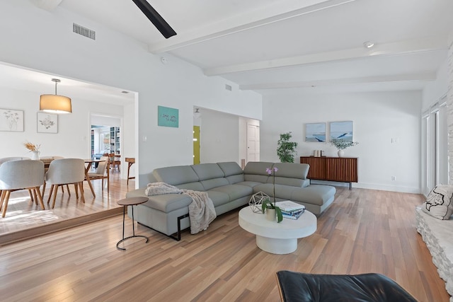 4405 Greystone Dr, Austin, TX 78731 - living room with beamed ceiling and light wood-style floors