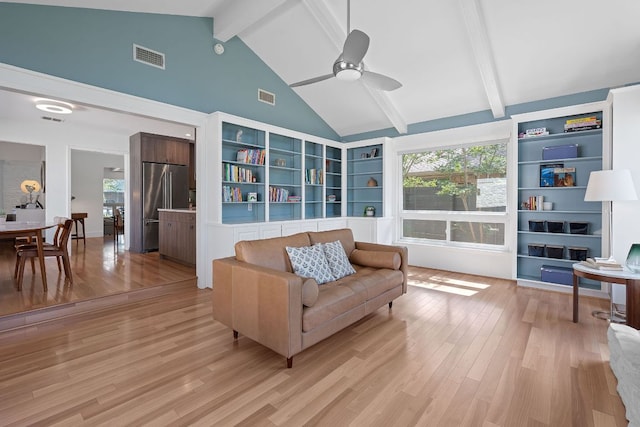 4405 Greystone Dr, Austin, TX 78731 - living room with beam ceiling, ceiling fan, light wood-style floors, healthy amount of natural light, and high vaulted ceiling