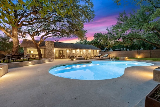 4405 Greystone Dr, Austin, TX 78731 - pool at dusk featuring a patio area, a fenced backyard, a hot tub, and french doors