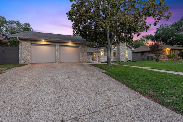 4405 Greystone Dr, Austin, TX 78731 - view of front of property featuring stone siding, driveway, and an attached garage