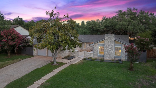 4405 Greystone Dr, Austin, TX 78731 - view of front of home featuring stone siding, a front yard, concrete driveway, a chimney, and an attached garage