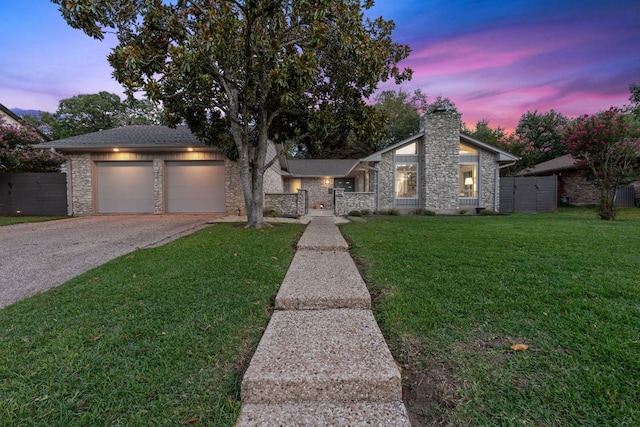 4405 Greystone Dr, Austin, TX 78731 - mid-century inspired home with stone siding, a chimney, asphalt driveway, and a garage