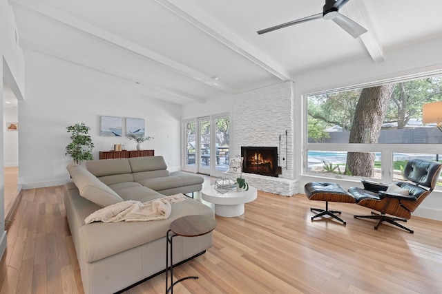4405 Greystone Dr, Austin, TX 78731 - living area featuring a stone fireplace, wood finished floors, and ceiling fan