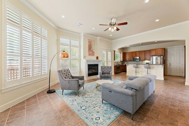 2800 Waymaker Way Unit 63, Austin, TX 78746 - living room with a ceiling fan, recessed lighting, ornamental molding, a glass covered fireplace, and arched walkways