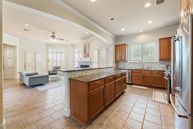 2800 Waymaker Way Unit 63, Austin, TX 78746 - kitchen featuring appliances with stainless steel finishes, recessed lighting, backsplash, open floor plan, and a fireplace
