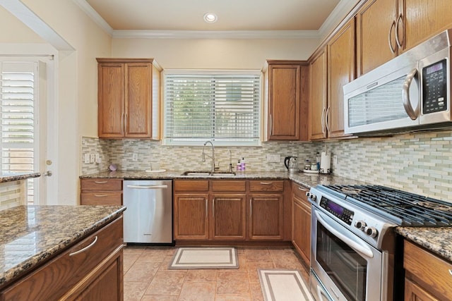 2800 Waymaker Way Unit 63, Austin, TX 78746 - kitchen with appliances with stainless steel finishes, brown cabinetry, stone counters, tasteful backsplash, and ornamental molding