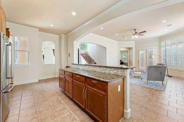 2800 Waymaker Way Unit 63, Austin, TX 78746 - kitchen featuring stainless steel refrigerator, arched walkways, healthy amount of natural light, a ceiling fan, and recessed lighting