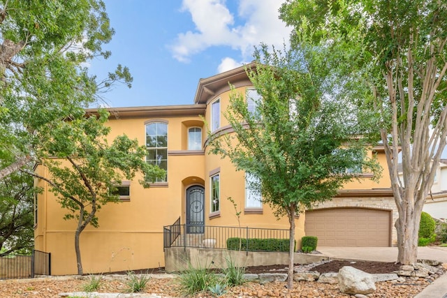 2800 Waymaker Way Unit 63, Austin, TX 78746 - mediterranean / spanish home with an attached garage, stucco siding, and concrete driveway