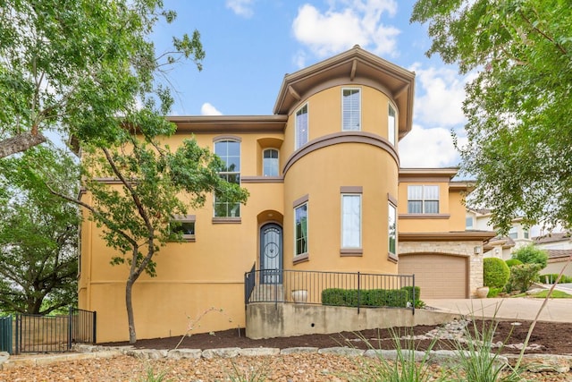 2800 Waymaker Way Unit 63, Austin, TX 78746 - mediterranean / spanish-style house with stucco siding, a garage, and driveway
