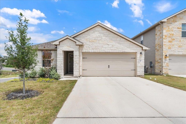 111 El Capitan Loop, Dripping Springs, TX 78620 - view of front of home with stone siding, concrete driveway, a garage, and a front yard