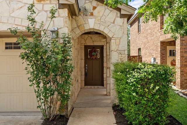 404 Buttercup Creek Blvd Unit 19, Cedar Park, TX 78613 - doorway to property with stone siding and a garage