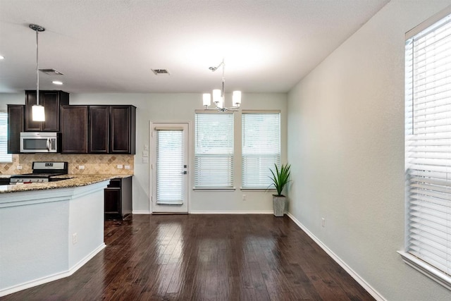 404 Buttercup Creek Blvd Unit 19, Cedar Park, TX 78613 - kitchen featuring backsplash, dark brown cabinetry, dark wood finished floors, stainless steel appliances, and a chandelier