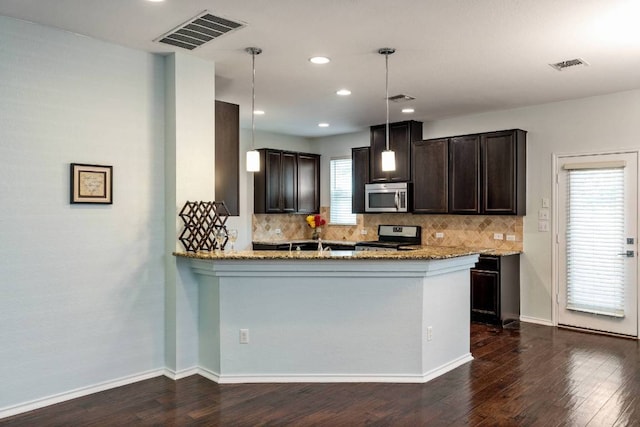 404 Buttercup Creek Blvd Unit 19, Cedar Park, TX 78613 - kitchen with light stone counters, decorative backsplash, appliances with stainless steel finishes, dark brown cabinetry, and recessed lighting